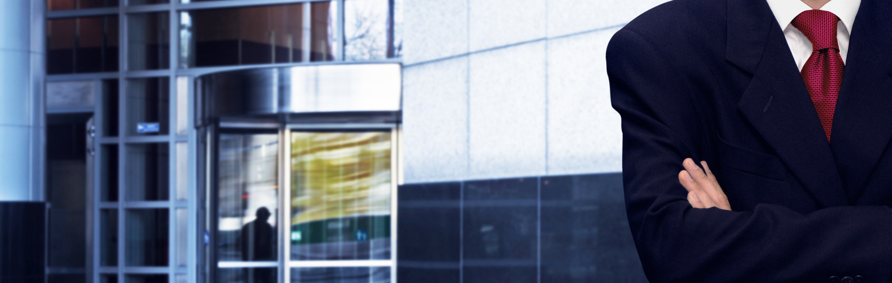 Confident businessman and bank office building in background